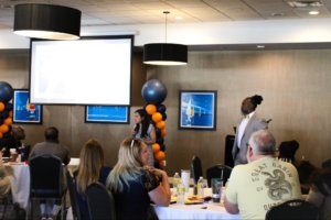 Members of the Lavinia Group present to the room of scholar teachers and staff.